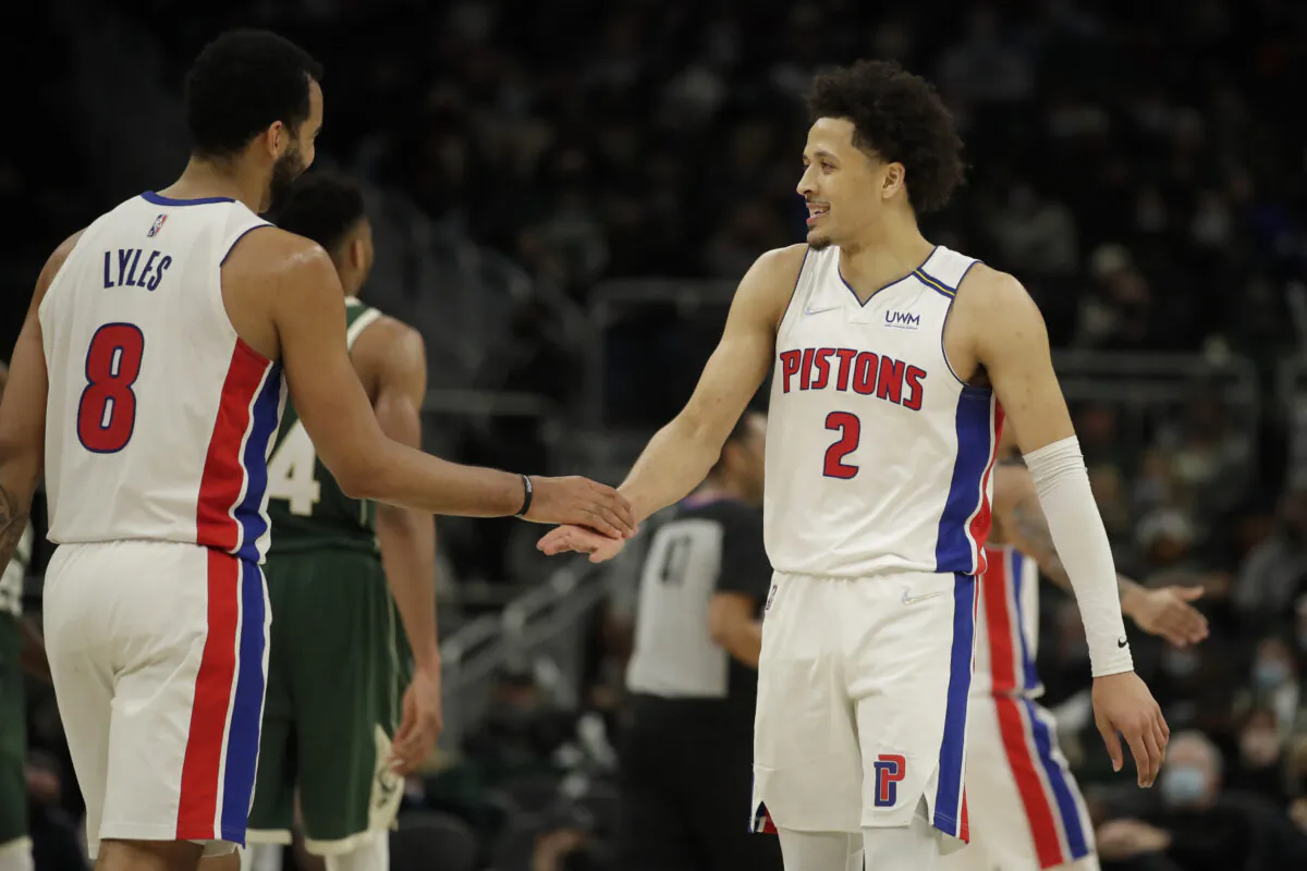 Detroit Pistons' Cade Cunningham (2) smiles with Trey Lyles (8), during an NBA game against the Milwaukee Bucks, in Milwaukee, Wis., on Jan. 3, 2022. (Aaron Gash/AP Photo)