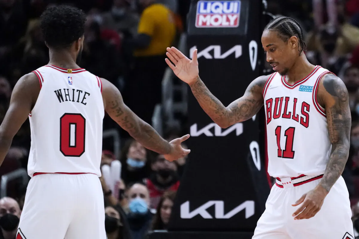Chicago Bulls forward DeMar DeRozan (R) celebrates with guard Coby White after scoring a basket during the second half of an NBA basketball game against the Orlando Magic in Chicago, on Jan. 3, 2022. (Nam Y. Huh/AP Photo)