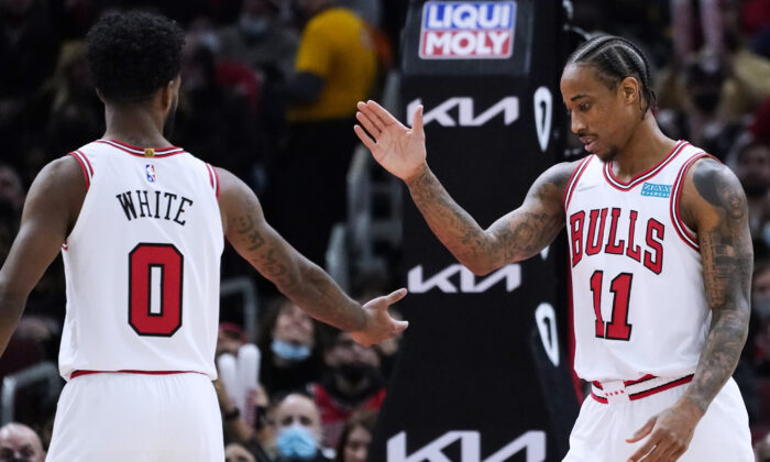 Chicago Bulls forward DeMar DeRozan (R) celebrates with guard Coby White after scoring a basket during the second half of an NBA basketball game against the Orlando Magic in Chicago, on Jan. 3, 2022. (Nam Y. Huh/AP Photo)