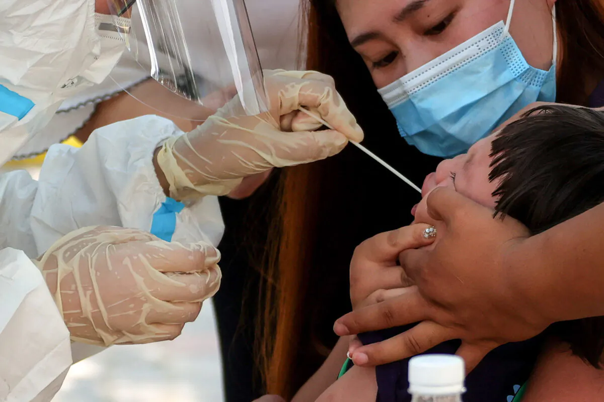 A child receives a nucleic acid test for COVID-19 in Zhengzhou, in central China's Henan Province on July 31, 2021. (-/AFP via Getty Images)