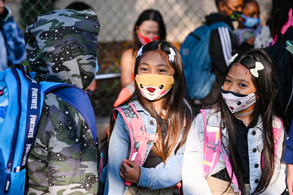 Students and parents arrive masked for the first day of the school year at Grant Elementary School in Los Angeles, on Aug. 16, 2021. (Robyn Beck/AFP via Getty Images)