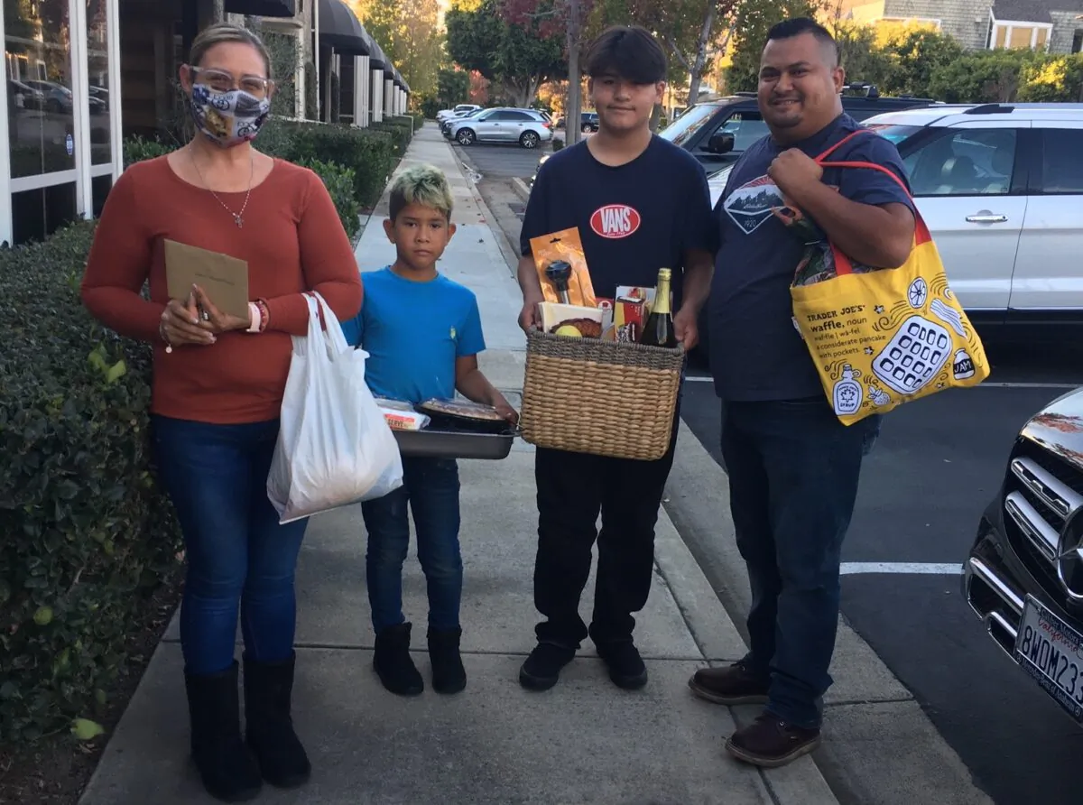 A family receives assistance from the Costa Mesa-based organization Serving People in Need. (Courtesy of Serving People in Need)