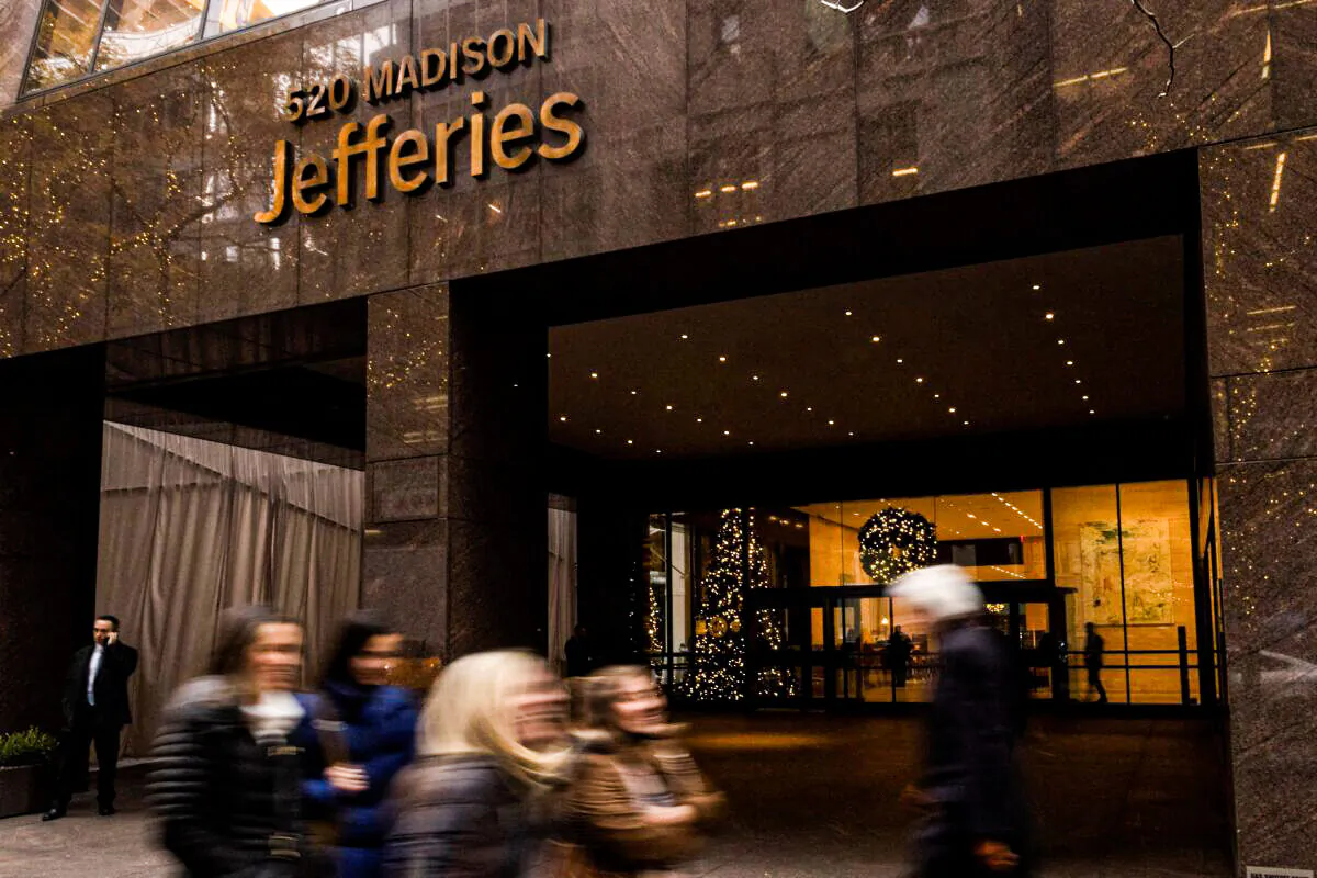 People walk outside of Jefferies Financial Group offices in Manhattan, N.Y., on Dec. 8, 2021. (Eduardo Munoz/Reuters)