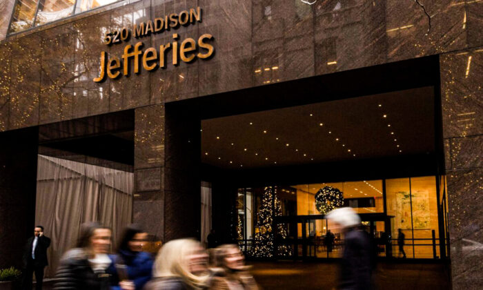 People walk outside of Jefferies Financial Group offices in Manhattan, N.Y., on Dec. 8, 2021. (Eduardo Munoz/Reuters)
