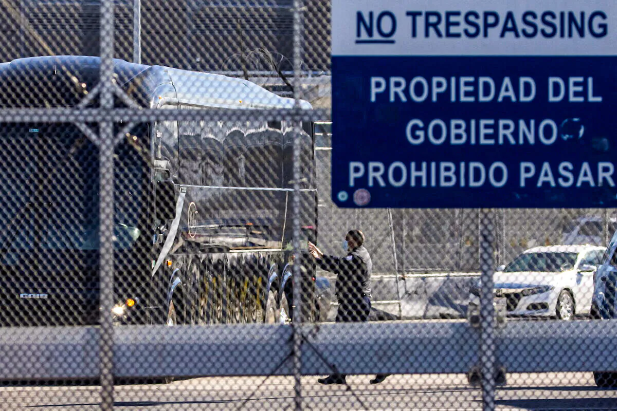 A bus leaves a closed border facility as migrants subject to a Trump-era asylum restriction program were expected to begin entry into the United States at the San Ysidro border crossing with Mexico, in San Diego, Calif., on Feb. 19, 2021. (Mike Blake/Reuters)