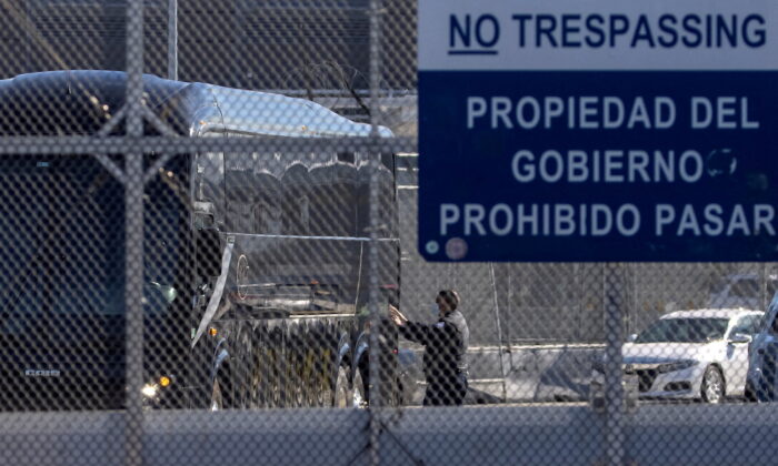 A bus leaves a closed border facility as migrants subject to a Trump-era asylum restriction program were expected to begin entry into the United States at the San Ysidro border crossing with Mexico, in San Diego, Calif., on Feb. 19, 2021. (Mike Blake/Reuters)
