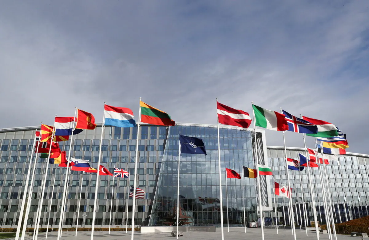 Flags wave outside the Alliance headquarters ahead of a NATO Defense Ministers meeting, in Brussels, Belgium, on Oct. 21, 2021. (Pascal Rossignol/Reuters)