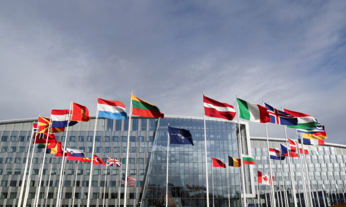 Flags wave outside the Alliance headquarters ahead of a NATO Defense Ministers meeting, in Brussels, Belgium, on Oct. 21, 2021. (Pascal Rossignol/Reuters)