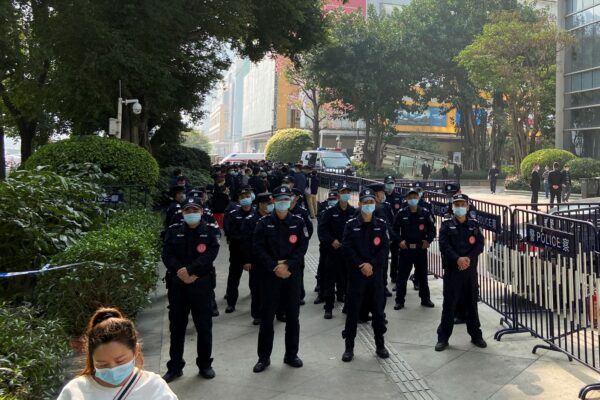 Police officers stand guard outside the Evergrande International Center