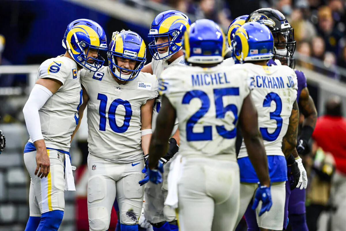 Los Angeles Rams wide receiver Cooper Kupp (10) and quarterback Matthew Stafford (9) are joined by teammates after they connected for a touchdown pass against the Baltimore Ravens during the first half of an NFL football game, in Baltimore, on Jan. 2, 2022. (Gail Burton/AP Photo)