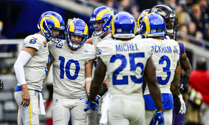 Los Angeles Rams wide receiver Cooper Kupp (10) and quarterback Matthew Stafford (9) are joined by teammates after they connected for a touchdown pass against the Baltimore Ravens during the first half of an NFL football game, in Baltimore, on Jan. 2, 2022. (Gail Burton/AP Photo)