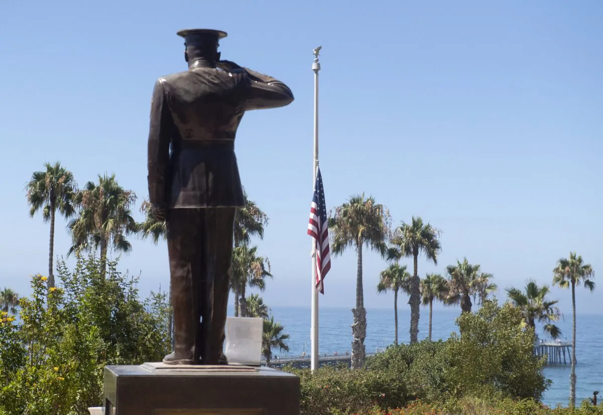 The U.S. flag is seen lowered to half-staff at Park Semper Fi in San Clemente, Calif., after a seafaring assault vehicle sank off the coast of Southern Calif., on July 31, 2020. (Paul Bersebach/The Orange County Register via AP)