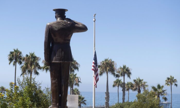The U.S. flag is seen lowered to half-staff at Park Semper Fi in San Clemente, Calif., after a seafaring assault vehicle sank off the coast of Southern Calif., on July 31, 2020. (Paul Bersebach/The Orange County Register via AP)