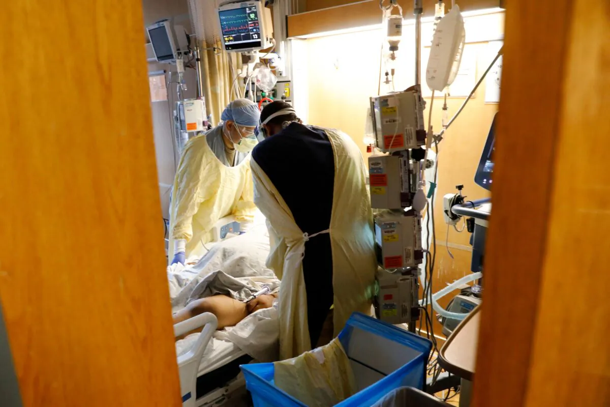 Medical personnel take care of a COVID-19 patient inside a hospital in Dearborn, Mich., on Dec. 17, 2021. (Jeff Kowalsky/AFP via Getty Images)