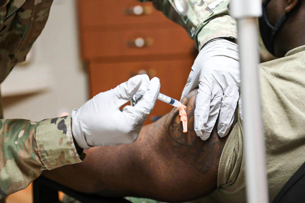 A member of the Navy receives a COVID-19 vaccine at U.S. Army Garrison Humphreys, South Korea, on Dec. 29, 2020. (U.S. Army photo by Spc. Erin Conway)