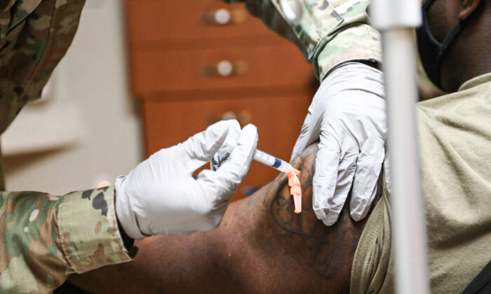 A member of the Navy receives a COVID-19 vaccine at U.S. Army Garrison Humphreys, South Korea, on Dec. 29, 2020. (U.S. Army photo by Spc. Erin Conway)
