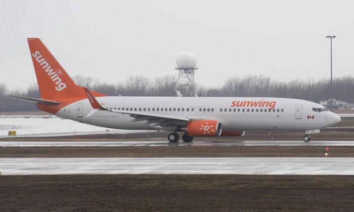 A Sunwing Airlines jet prepares to take-off at Montrealâ€“Trudeau International Airport, March 20, 2020. (The Canadian Press/Graham Hughes)