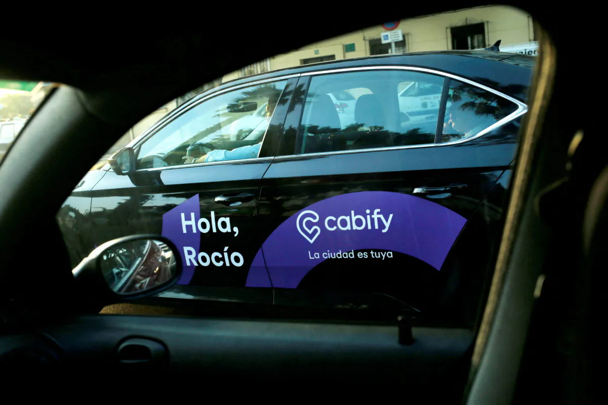 A Cabify taxi car is seen through the window of a car in Malaga, southern Spain, on Aug. 3, 2018. (Jon Nazca/Reuters)
