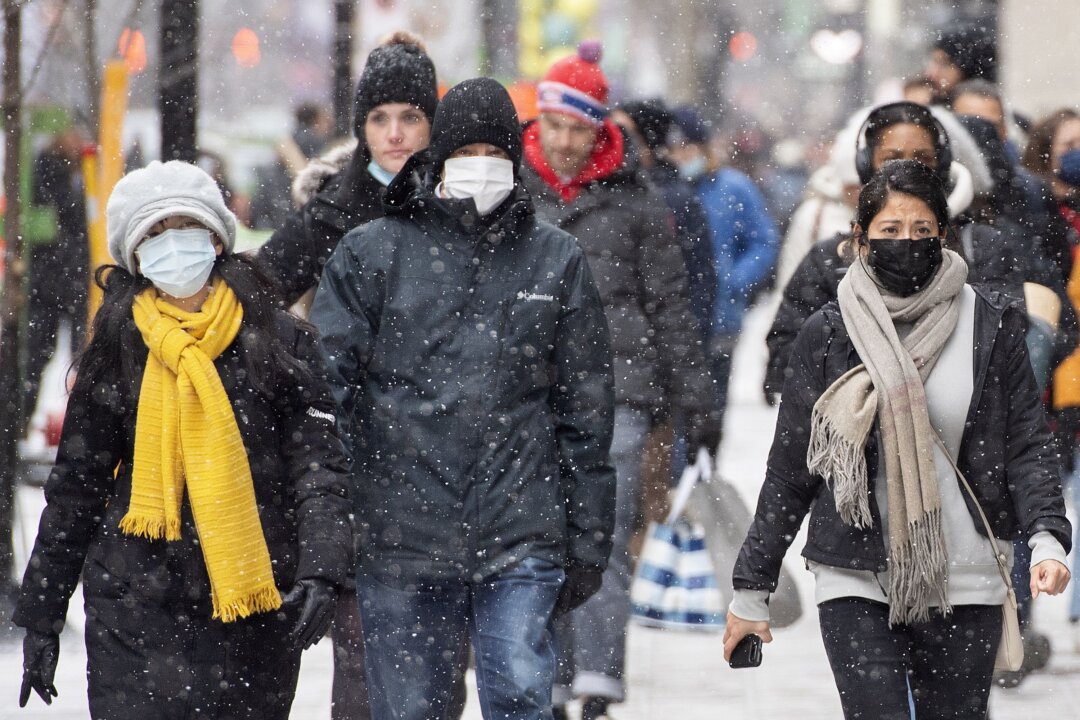  
People walk along Ste-Catherine Street in Montreal on Dec. 4, 2021. (The Canadian Press/Graham Hughes)
