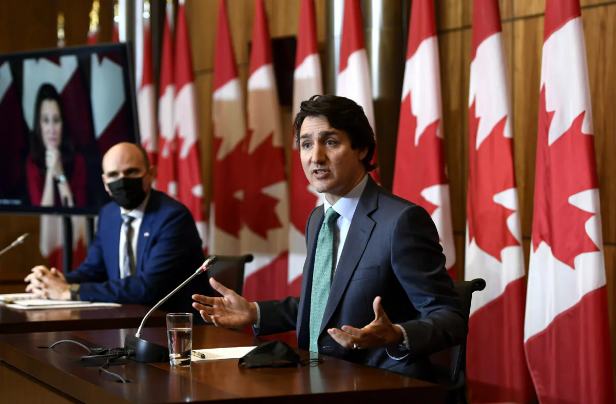 Prime Minister Justin Trudeau speaks as Minister of Health Jean-Yves Duclos and Deputy Prime Minister Chrystia Freeland participate in a news conference in Ottawa on Jan. 5, 2022. (The Canadian Press/Justin Tang)