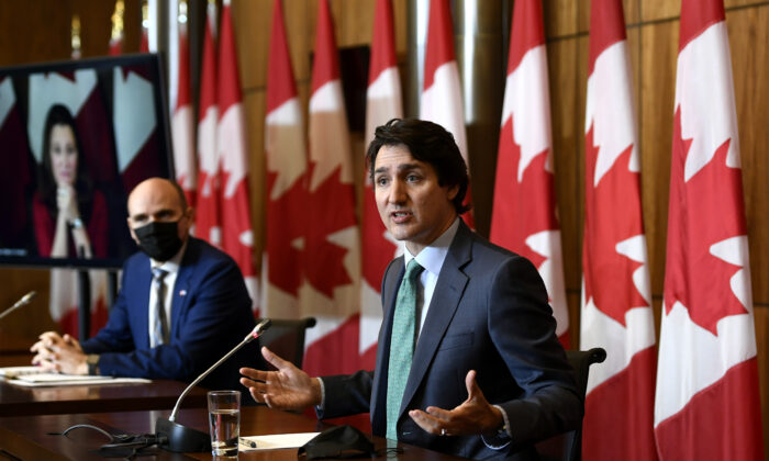 Prime Minister Justin Trudeau speaks as Minister of Health Jean-Yves Duclos and Deputy Prime Minister and Minister of Finance Chrystia Freeland, seen via videoconference, participate in a news conference on the COVID-19 pandemic, in Ottawa on Jan. 5, 2022. (The Canadian Press/Justin Tang)