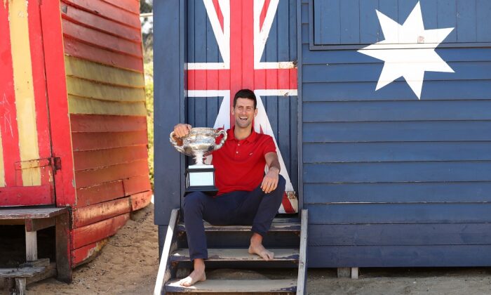 Novak Djokovic of Serbia poses with the Norman Brookes Challenge Cup after winning the 2021 Australian Open Men's Final, at Brighton Beach in Melbourne, Australia on Feb. 22, 2021. (Graham Denholm/Getty Images)