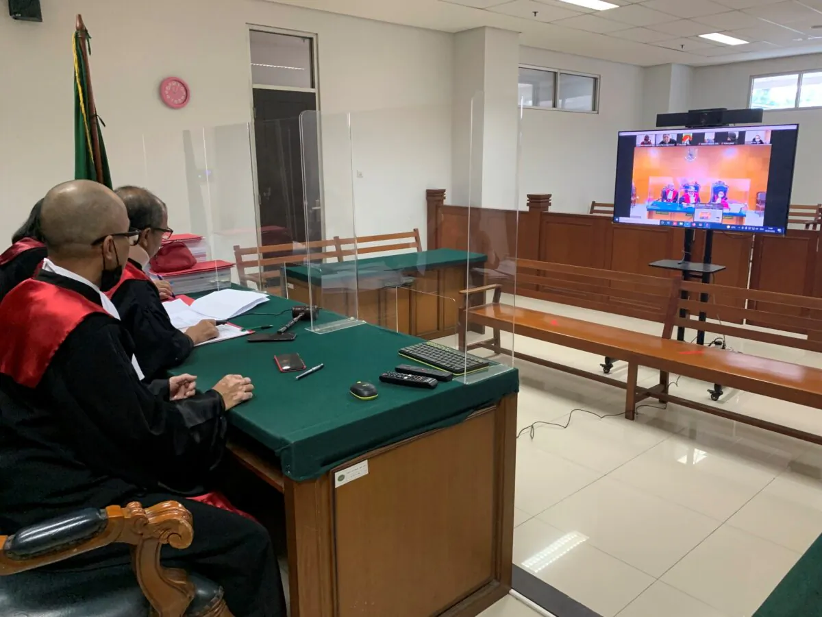 Judges attend a trial hearing of suspected militant Arif Sunarso, who is better known as Zulkarnaen and remotely appeared in the trial, at East Jakarta District Court in Jakarta, Indonesia, on Jan. 5, 2022. (Arie Firdaus/ AP Photo)