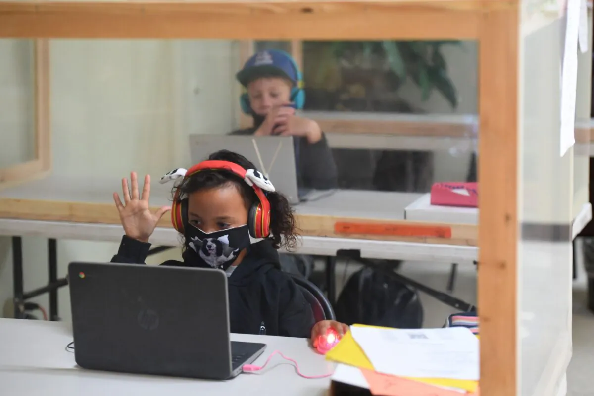 Students follow along remotely with their regular school teacher's online live lesson from separated by plastic barriers at STAR Eco Station Tutoring & Enrichment Center on September 10, 2020 in Culver City, California. - California public school students will continue to learn at home, in private learning pods, or at specialized enrichment centers like Star Eco Station as the coronavirus pandemic continues, after a lawsuit brought by the Orange County Board of Education seeking to compel the state to reopen public schools was shot down by the California Supreme Court on September 10. (Photo by Robyn Beck / AFP) (Photo by ROBYN BECK/AFP via Getty Images)