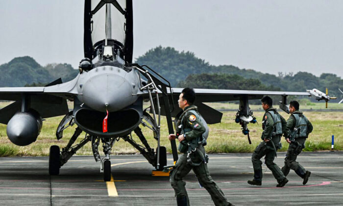 Taiwanese air force pilots run pass an armed U.S.-made F-16V fighter jet at an air force base in Chiayi, a city in southern Taiwan, on Jan. 5, 2022. (Sam Yeh/AFP via Getty Images)