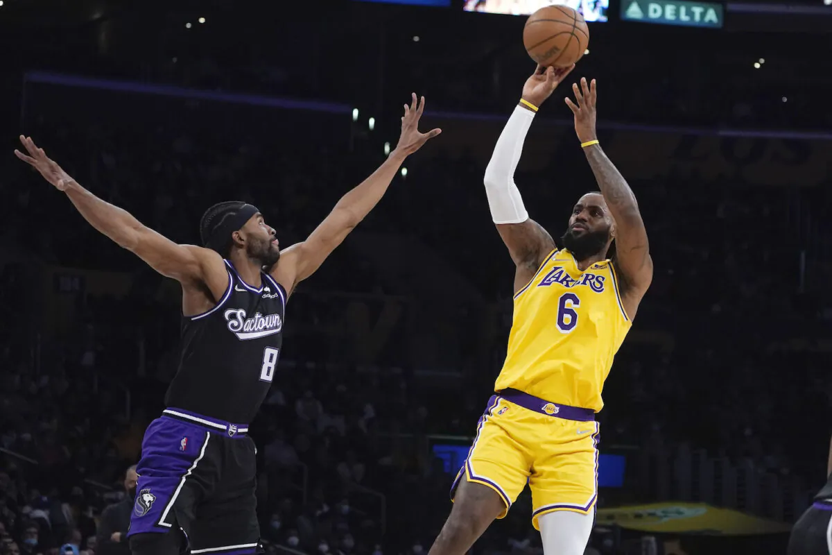 Los Angeles Lakers forward LeBron James (6) shoots over Sacramento Kings forward Maurice Harkless (8) during the first half of an NBA basketball game in Los Angeles on Jan. 4, 2022. (AP Photo/Marcio Jose Sanchez)