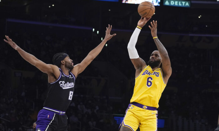 Los Angeles Lakers forward LeBron James (6) shoots over Sacramento Kings forward Maurice Harkless (8) during the first half of an NBA basketball game in Los Angeles on Jan. 4, 2022. (AP Photo/Marcio Jose Sanchez)