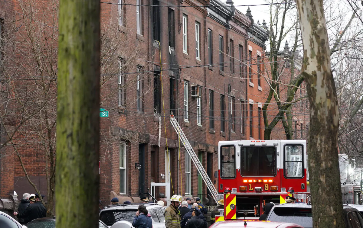 Philadelphia firefighters work at the scene of a deadly row house fire in the Fairmount neighborhood of Philadelphia on Jan. 5, 2022. (Matt Rourke/AP Photo)