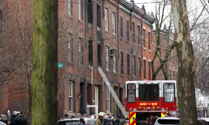 Philadelphia firefighters work at the scene of a deadly row house fire in the Fairmount neighborhood of Philadelphia on Jan. 5, 2022. (Matt Rourke/AP Photo)