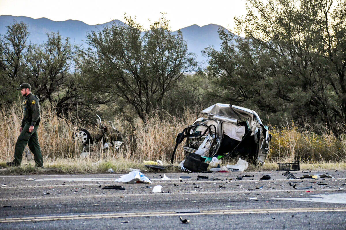A Border Patrol agent walks from the wreckage of Wanda Sitowski’s car after a 16-year-old smuggler ran a red light at 105 miles per hour and caused a fatal crash in Cochise County, Ariz., on Oct. 30, 2021. (Zach Bennett/Sierra Vista News Network)