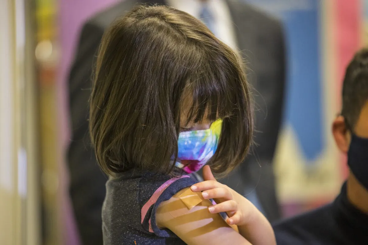 A 5-year-old girl looks at her arm after getting a Pfizer COVID-19 vaccine in New York City on Nov. 8, 2021. (Michael M. Santiago/Getty Images)