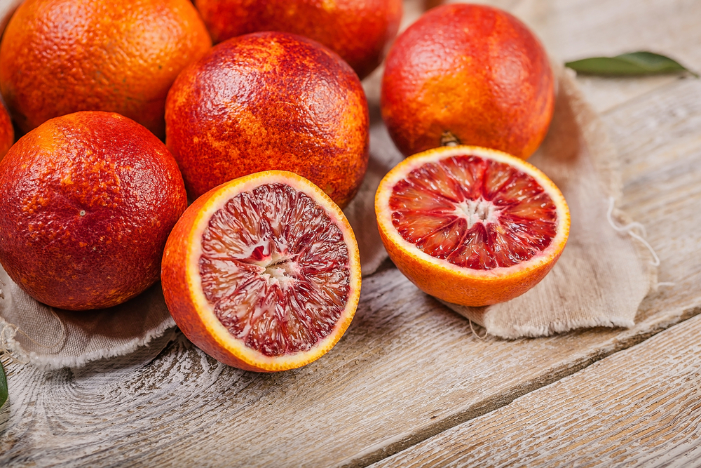 Close-up,Juicy,Red,Sicilian,Oranges,On,A,Wooden,Table.,Seasonal