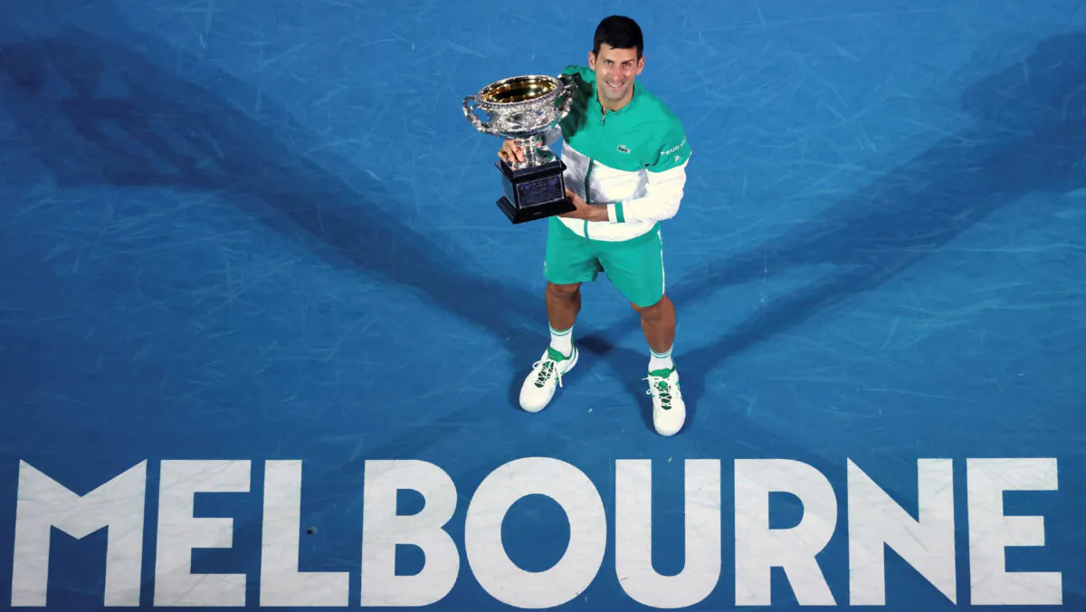 Serbia's Novak Djokovic holds the Norman Brookes Challenge Cup after defeating Russia's Daniil Medvedev in the men's singles final at the Australian Open tennis championship in Melbourne, Australia, on Feb. 21, 2021. (Hamish Blair/AP Photo)