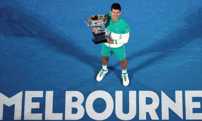 Serbia's Novak Djokovic holds the Norman Brookes Challenge Cup after defeating Russia's Daniil Medvedev in the men's singles final at the Australian Open tennis championship in Melbourne, Australia, on Feb. 21, 2021. (Hamish Blair/AP Photo)