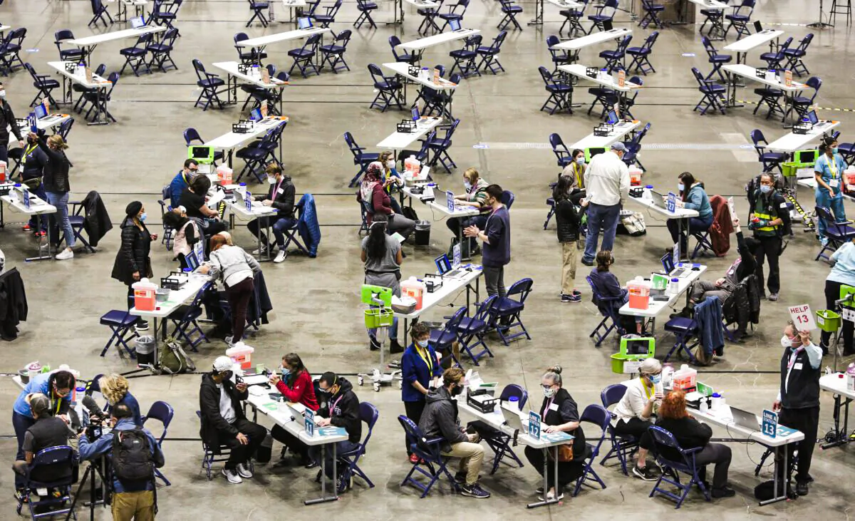 People receive the Pfizer Covid-19 vaccine during opening day of the Community Vaccination Site at the Lumen Field Event Center in Seattle, Wash., on March 13, 2021. (Jason Redmond/AFP via Getty Images)