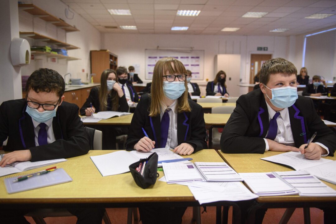 Year 10 students wear masks as they take part in a science class at Park Lane Academy in Halifax, northwest England, on Jan. 4, 2022. (Oli Scarff/AFP via Getty Images)