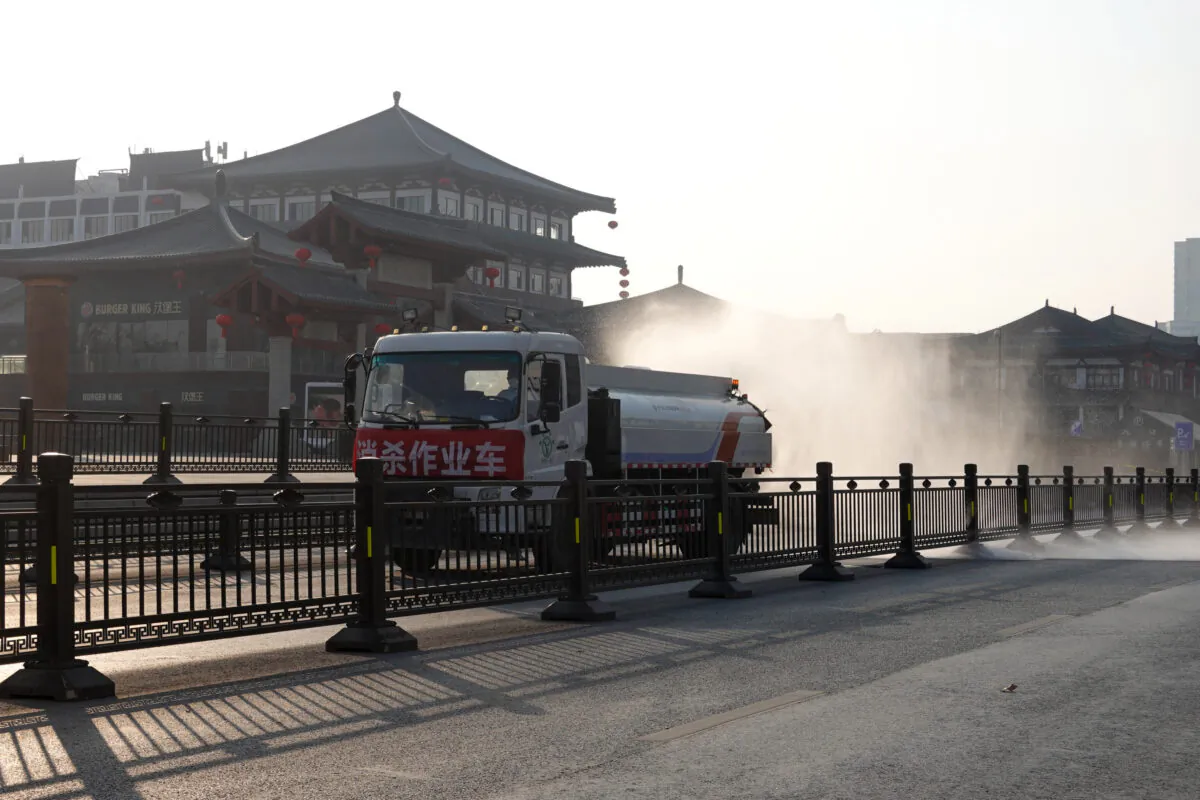 A truck sprays disinfectant on street in Xi'an in China's northern Shaanxi Province, amid a COVID-19 lockdown, on Dec. 31, 2021. (STR/AFP via Getty Images)