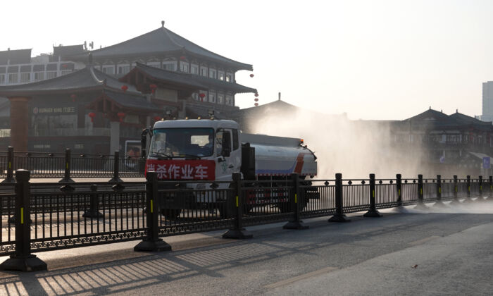 A truck sprays disinfectant on street in Xi'an in China's northern Shaanxi Province, amid a COVID-19 lockdown, on Dec. 31, 2021. (STR/AFP via Getty Images)