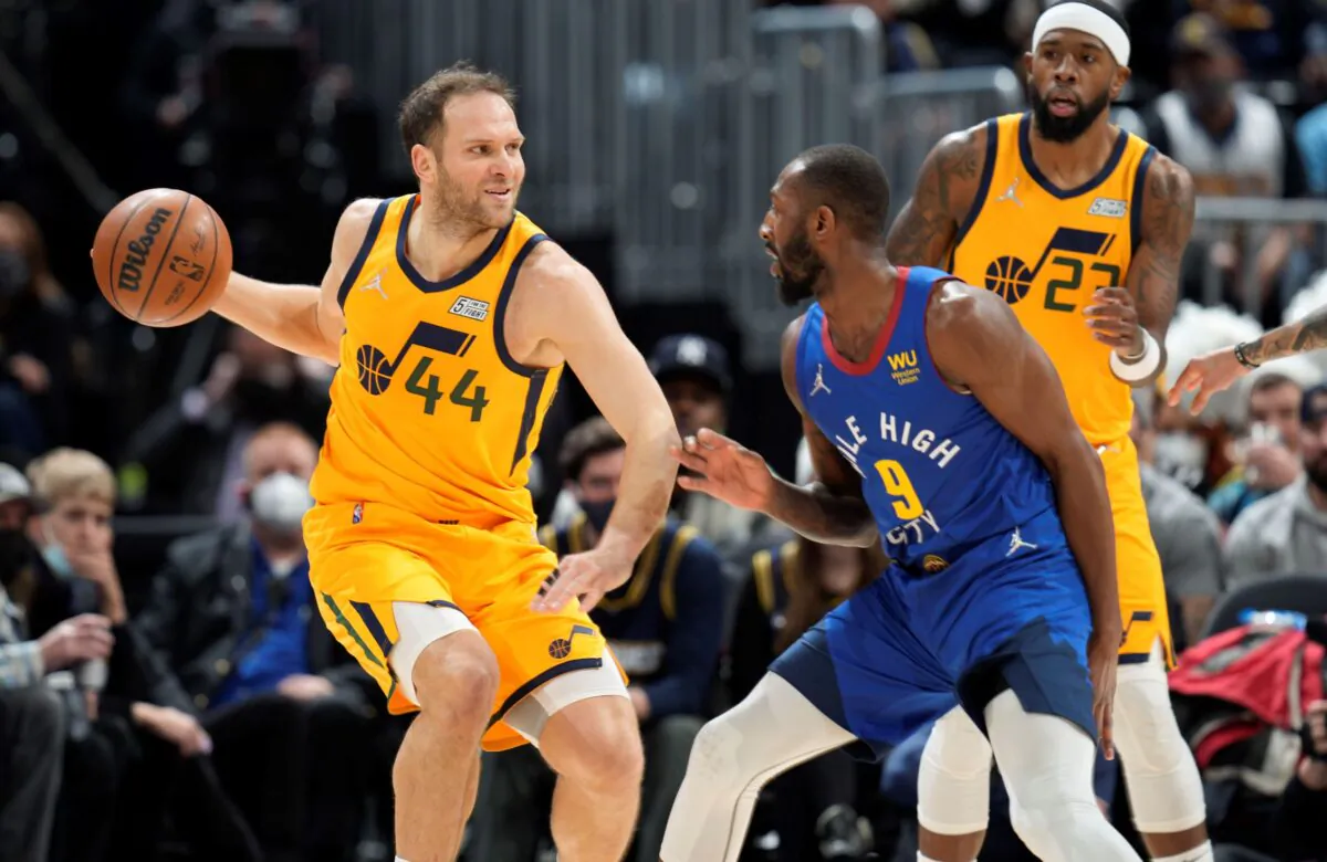 Utah Jazz forward Bojan Bogdanovic, left, looks to pass the ball as Denver Nuggets guard Davon Reed defends in the first half of an NBA basketball game in Denver, on Jan. 5, 2022. (David Zalubowski/AP Photo)