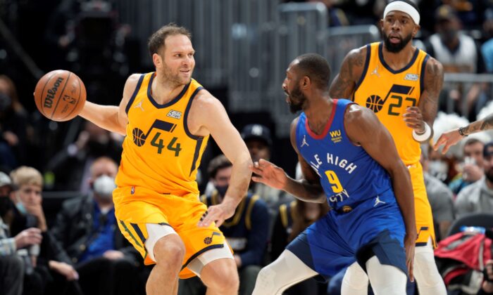 Utah Jazz forward Bojan Bogdanovic, left, looks to pass the ball as Denver Nuggets guard Davon Reed defends in the first half of an NBA basketball game in Denver, on Jan. 5, 2022. (David Zalubowski/AP Photo)