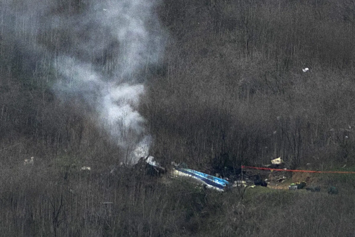 Wreckage of the crashed helicopter that was carrying former NBA star Kobe Bryant and his 13-year-old daughter Gianna smolders on the ground in Calabasas, Calif., on Jan. 26, 2020. (David McNew/Getty Images)