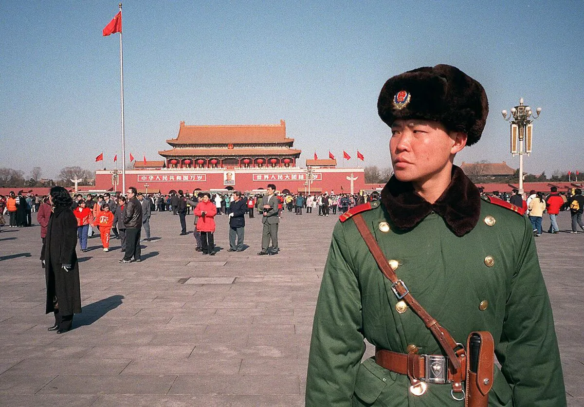 A Chinese military policeman patrols Tiananmen Square in Beijing on Feb. 6, 2000. (STEPHEN SHAVER/AFP via Getty Images)