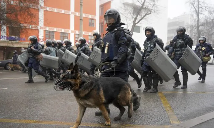 Riot police walk to block demonstrators gathering during a protest in Almaty, Kazakhstan, on Jan. 5, 2022. (Vladimir Tretyakov/AP Photo)