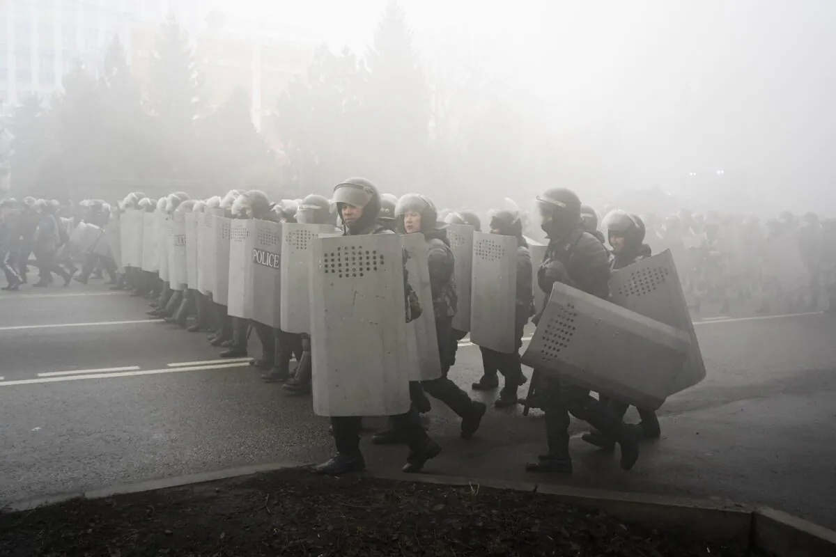 Riot police walk to block demonstrators during a protest in Almaty, Kazakhstan, on Jan. 5, 2022. (Vladimir Tretyakov/AP Photo)