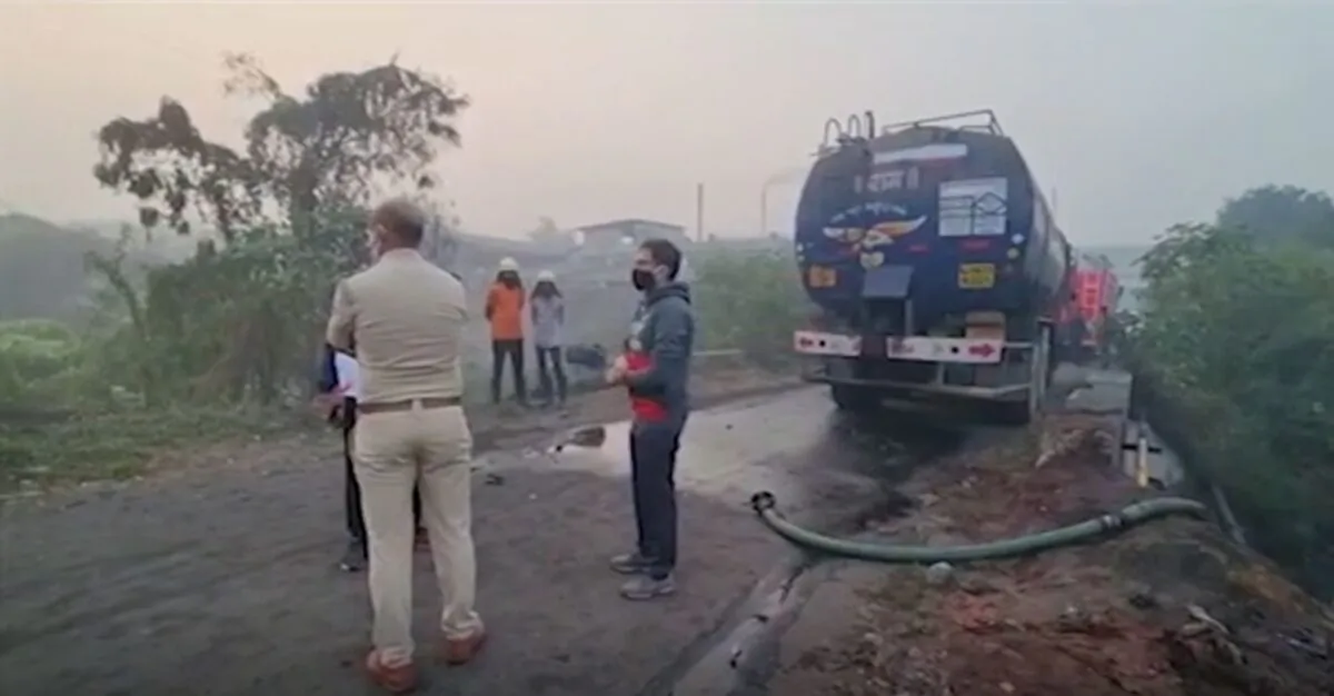 Various of parked industrial tanker, police officers at a gas leak site in Surat, a city in Gujarat state, in western India, on Jan. 6, 2022. (AP/Screenshot via The Epoch Times)