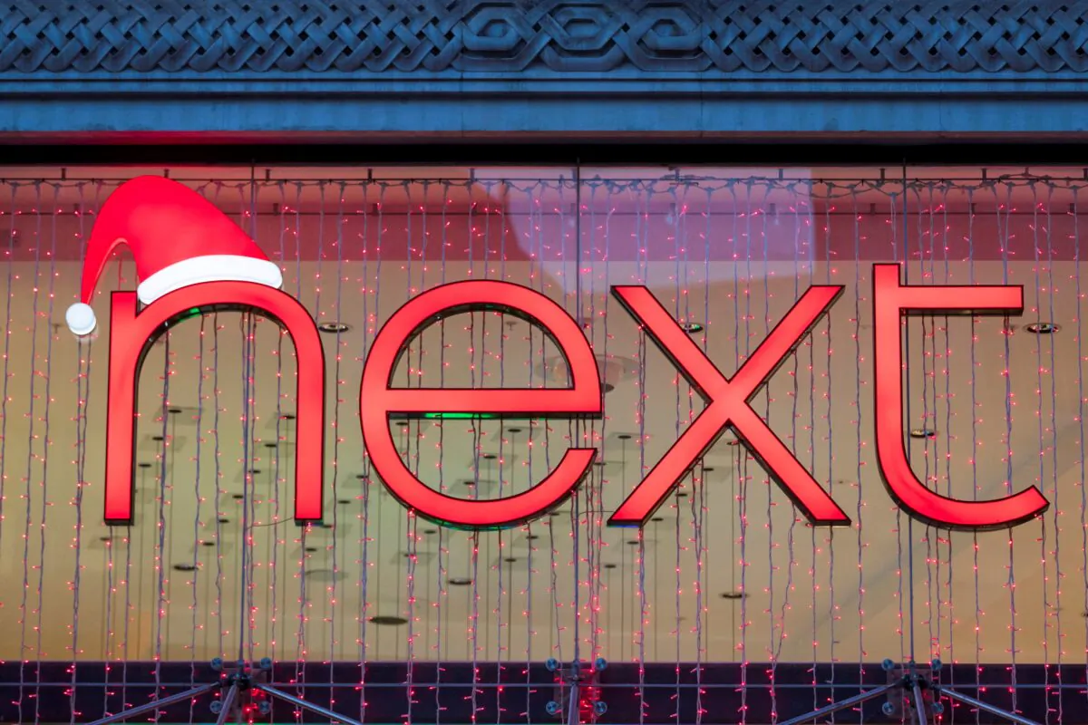 A Christmas themed logo of clothing retailer Next is seen at a store in London, on Dec. 2, 2021. (May James/Reuters)